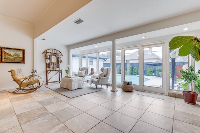 unfurnished living room featuring ornamental molding, plenty of natural light, and light tile patterned flooring