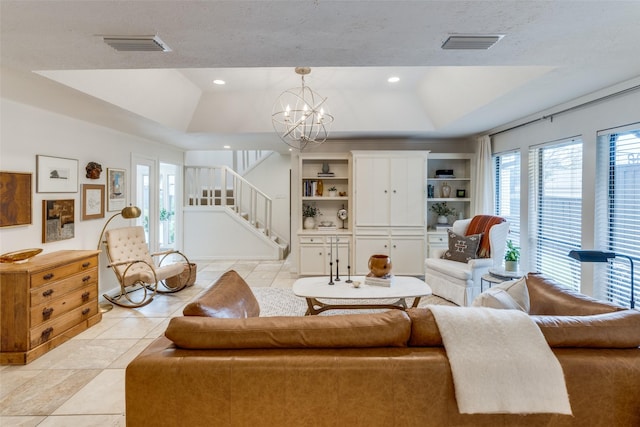 living area with lofted ceiling, visible vents, stairway, light tile patterned flooring, and a chandelier