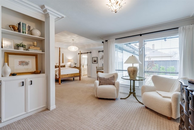 sitting room featuring light colored carpet, crown molding, a notable chandelier, and a barn door