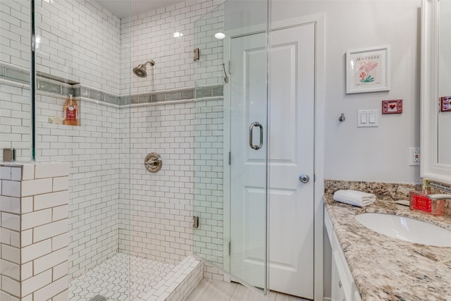 bathroom featuring a stall shower and vanity