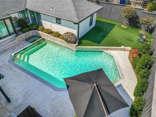 view of swimming pool featuring a fenced in pool, a patio, a lawn, a fenced backyard, and an in ground hot tub