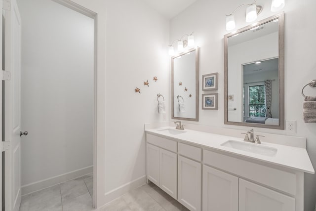 full bath featuring double vanity, ensuite bath, baseboards, and a sink