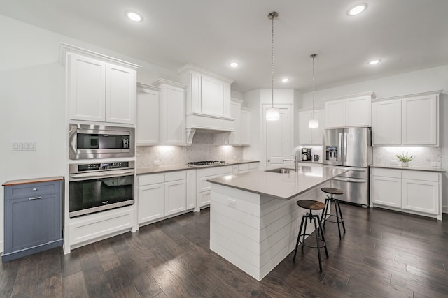 kitchen featuring dark wood-style floors, stainless steel appliances, and white cabinetry