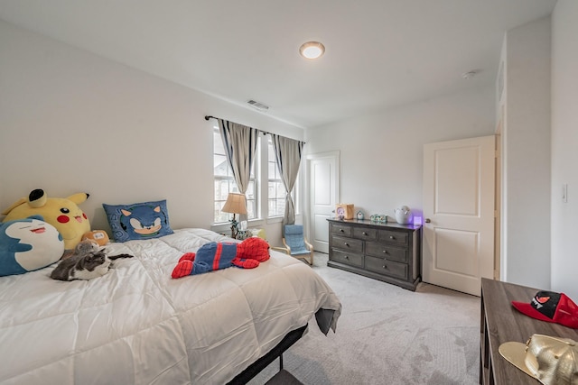 bedroom featuring light carpet and visible vents