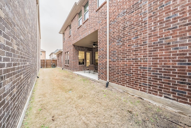 view of yard featuring fence private yard, a patio area, and ceiling fan