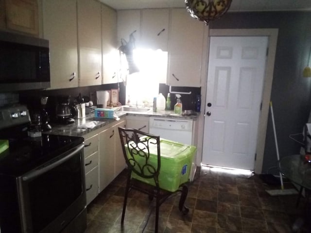 kitchen featuring stainless steel appliances, a sink, and white cabinetry