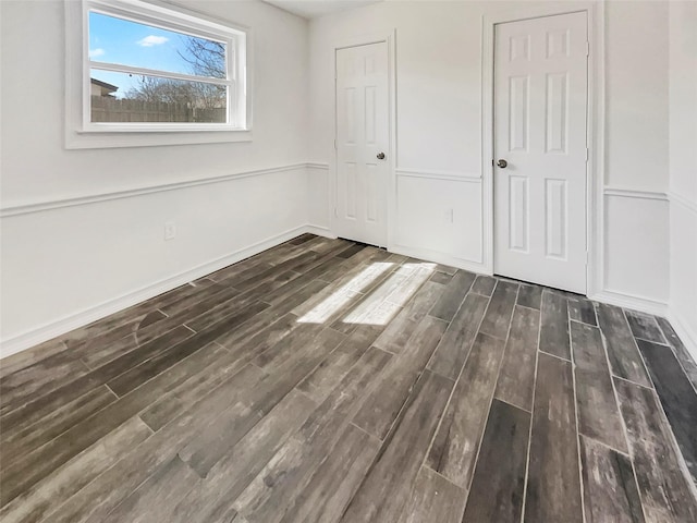 unfurnished bedroom featuring baseboards and wood finished floors