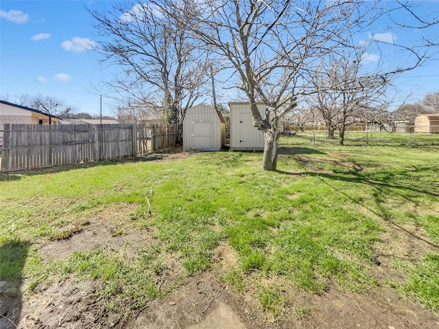 view of yard with a storage shed, an outdoor structure, and fence