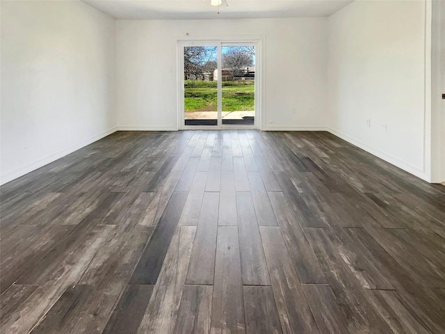 empty room featuring dark wood finished floors and baseboards