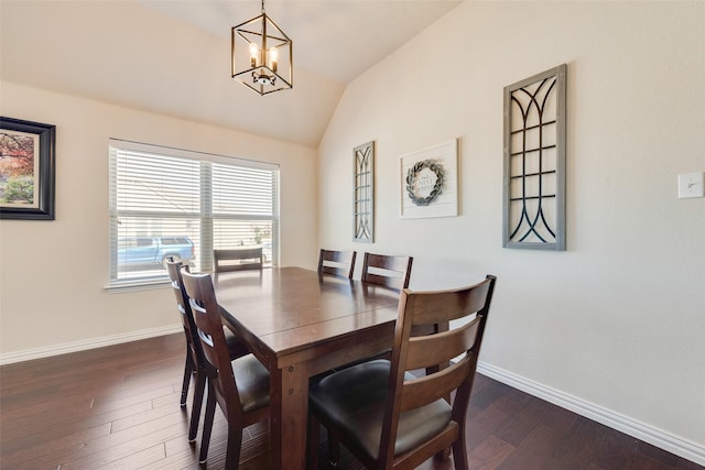 dining room featuring dark wood finished floors, vaulted ceiling, and baseboards