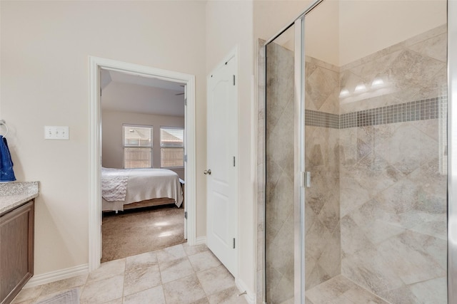 bathroom featuring a shower stall, baseboards, connected bathroom, and vanity