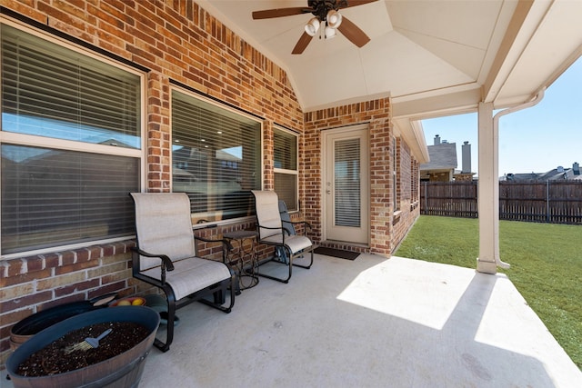 view of patio / terrace featuring ceiling fan and fence