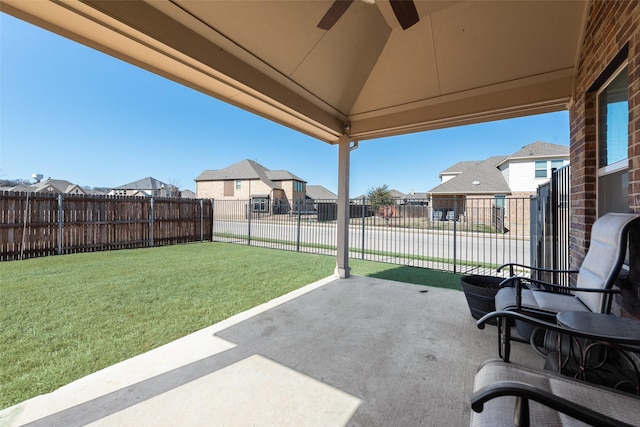 view of patio featuring ceiling fan, a fenced backyard, and a residential view