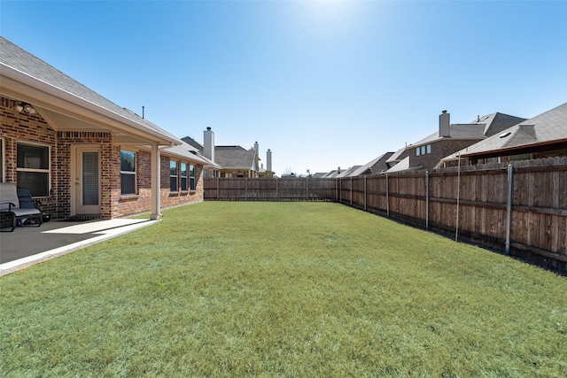 view of yard with a patio area and a fenced backyard