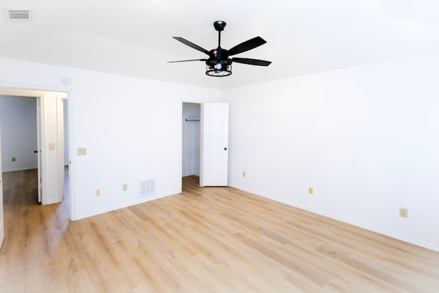 unfurnished bedroom with a closet, baseboards, visible vents, and light wood finished floors