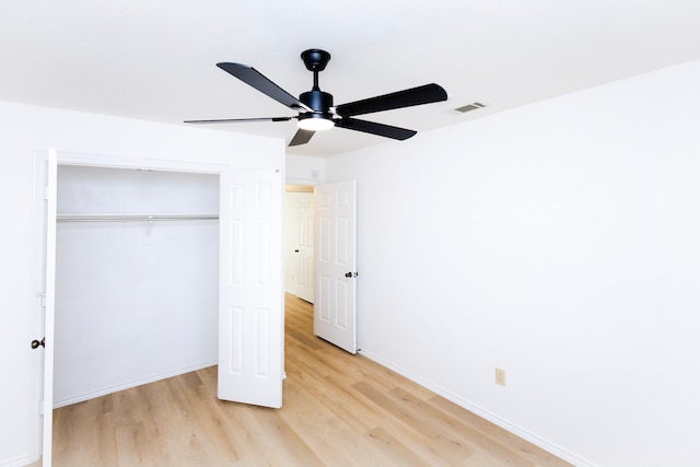 unfurnished bedroom with ceiling fan, visible vents, baseboards, light wood-style floors, and a closet