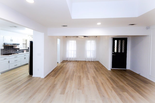 interior space with recessed lighting, visible vents, light wood-style flooring, and baseboards