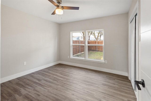 unfurnished bedroom featuring a closet, baseboards, and wood finished floors