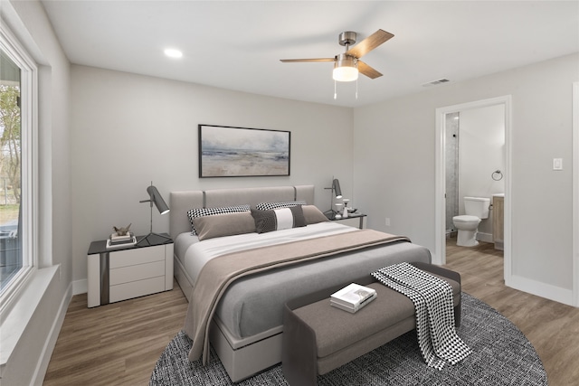 bedroom with light wood-type flooring, visible vents, and baseboards