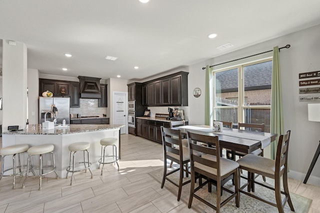 dining space with recessed lighting, visible vents, baseboards, and wood tiled floor