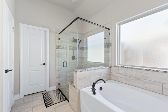 full bath featuring a stall shower and a garden tub