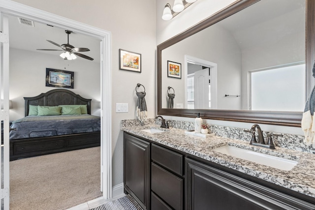 bathroom with double vanity, visible vents, a ceiling fan, and a sink