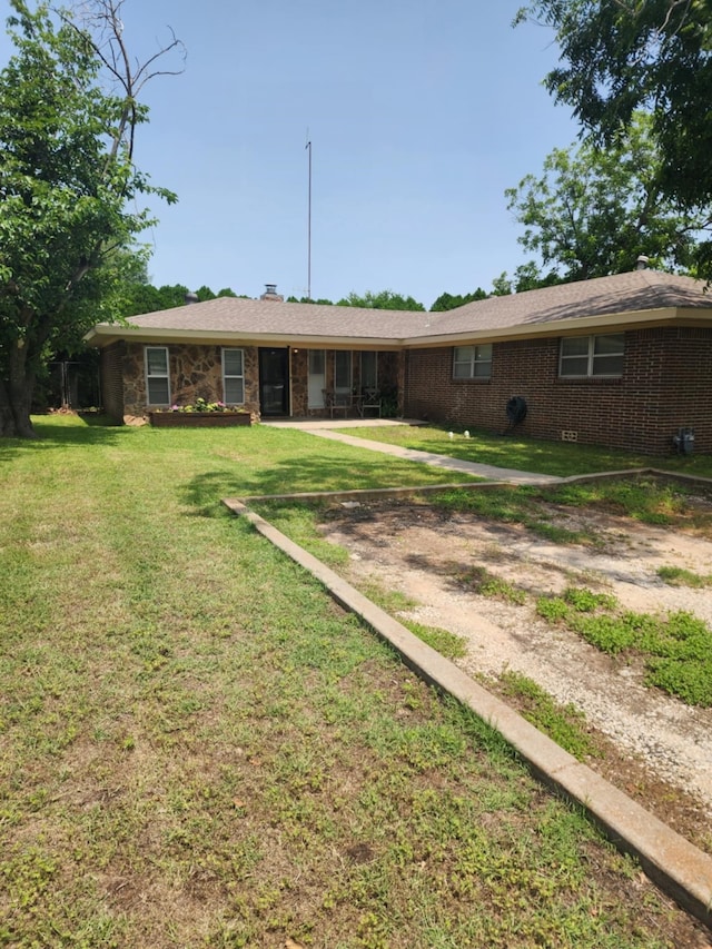1500 Nugent St, Bowie, TX 76230 - rear view of property with a yard and brick siding