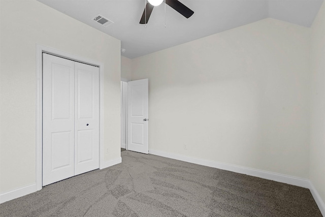 unfurnished bedroom with carpet floors, baseboards, visible vents, and a closet