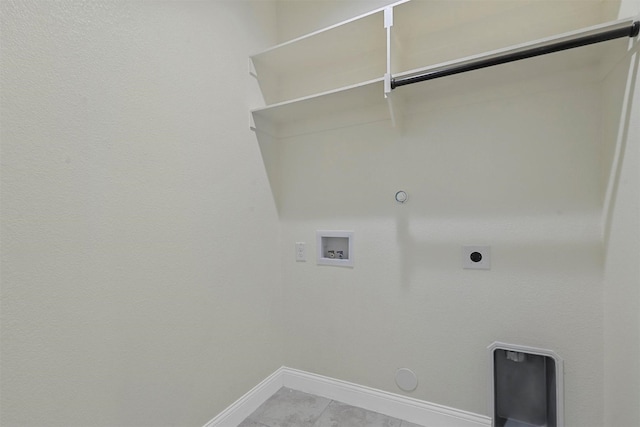 clothes washing area featuring hookup for a gas dryer, hookup for a washing machine, baseboards, and electric dryer hookup