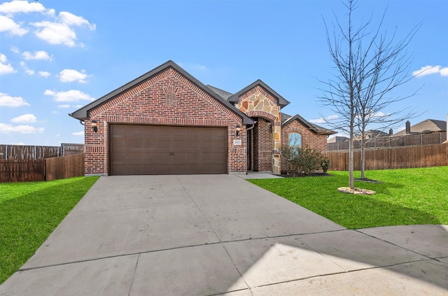 view of front of house with a front yard, brick siding, and fence