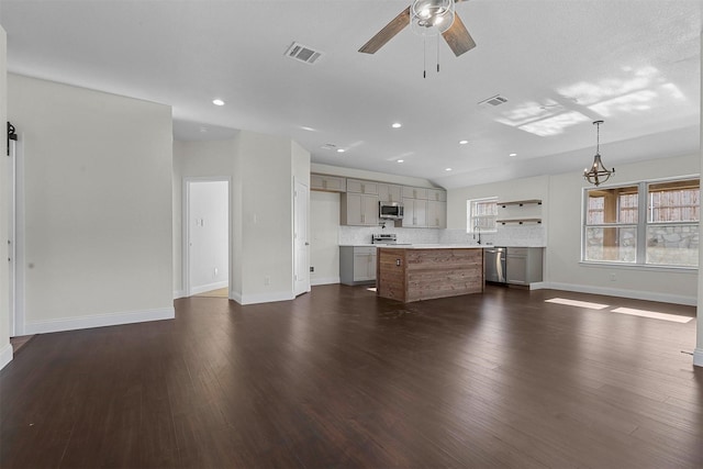 unfurnished living room featuring dark wood finished floors, visible vents, ceiling fan, and recessed lighting