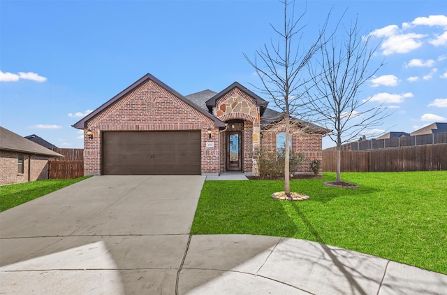 traditional home featuring an attached garage, a front yard, fence, and brick siding