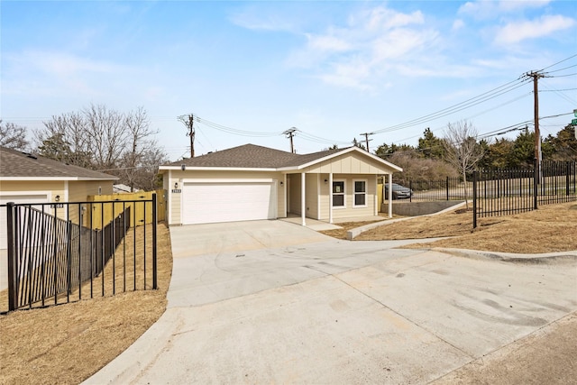view of front of home with concrete driveway, roof with shingles, fence, and an attached garage
