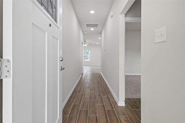 hall featuring wood tiled floor, visible vents, baseboards, and recessed lighting