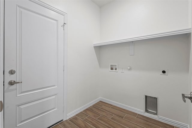 laundry area featuring wood finish floors, hookup for a washing machine, gas dryer hookup, electric dryer hookup, and laundry area