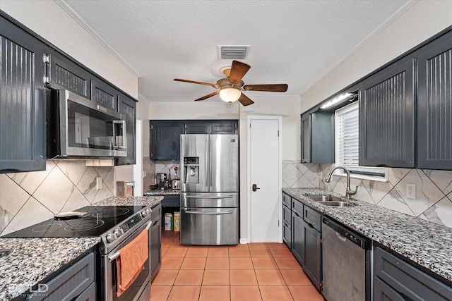 kitchen featuring light stone countertops, visible vents, stainless steel appliances, and a sink