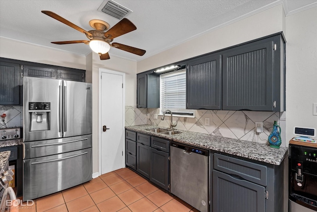 kitchen featuring light tile patterned floors, visible vents, light stone countertops, stainless steel appliances, and a sink