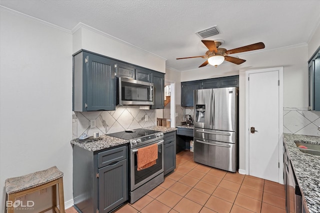 kitchen featuring stainless steel appliances, visible vents, a sink, and crown molding