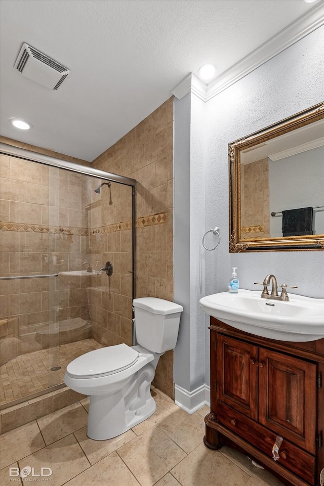 bathroom featuring visible vents, a shower stall, toilet, and vanity