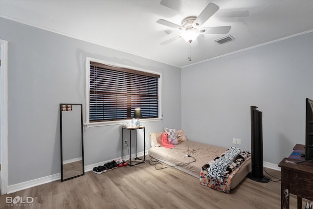 bedroom featuring visible vents, baseboards, and wood finished floors