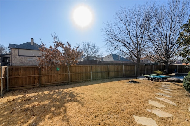 view of yard with a fenced backyard