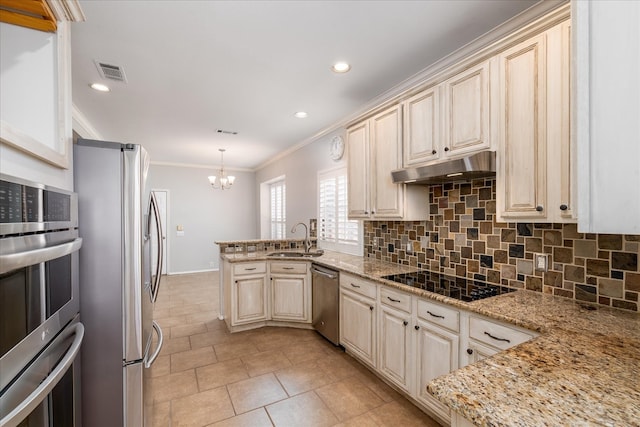 kitchen with a sink, under cabinet range hood, crown molding, visible vents, and appliances with stainless steel finishes