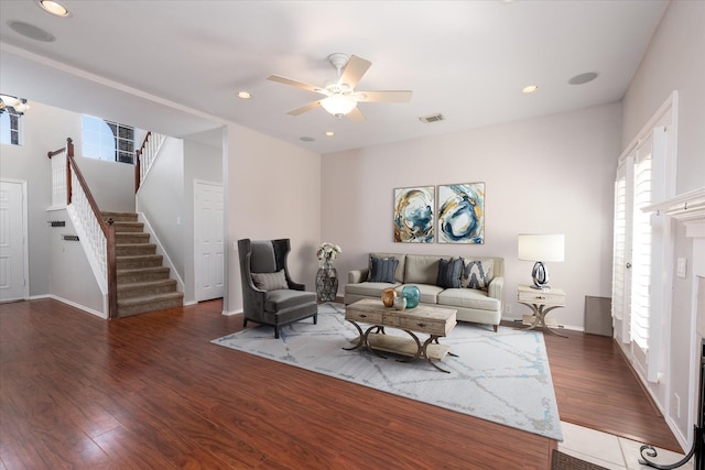 living room with recessed lighting, a fireplace, wood finished floors, visible vents, and stairway