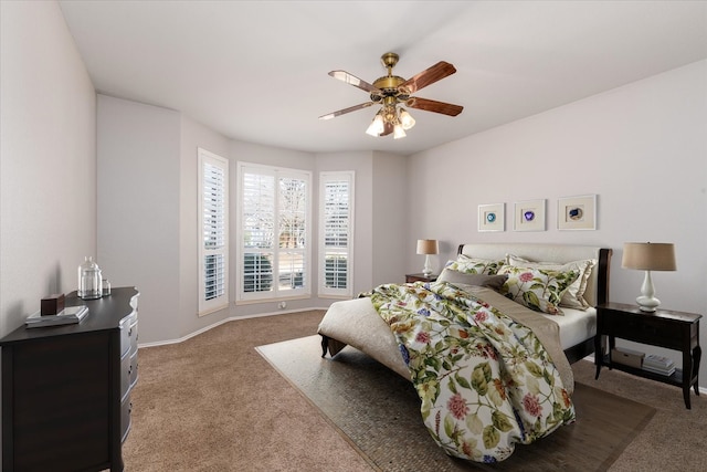 carpeted bedroom with a ceiling fan and baseboards