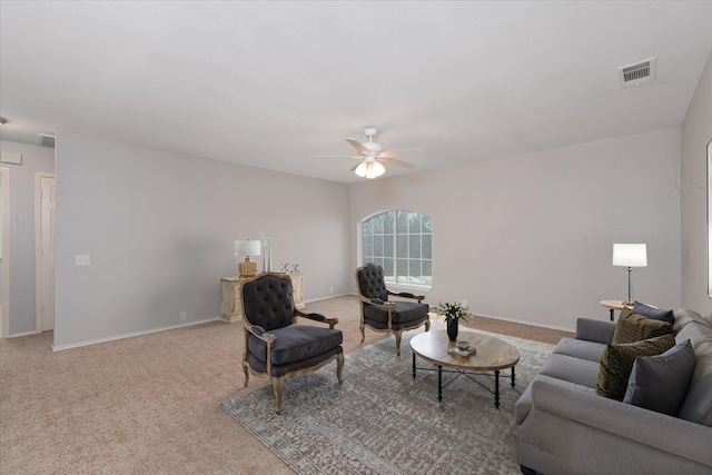 living room featuring carpet floors, baseboards, visible vents, and a ceiling fan