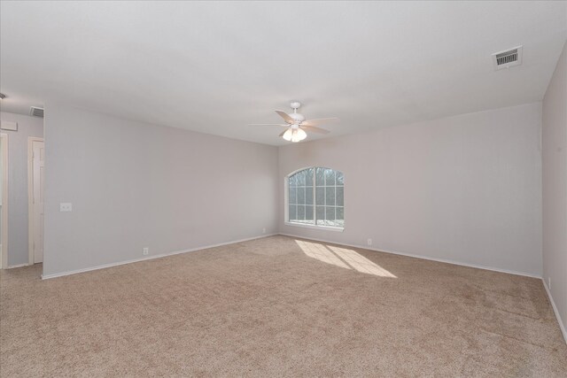 unfurnished room featuring baseboards, visible vents, a ceiling fan, and carpet floors