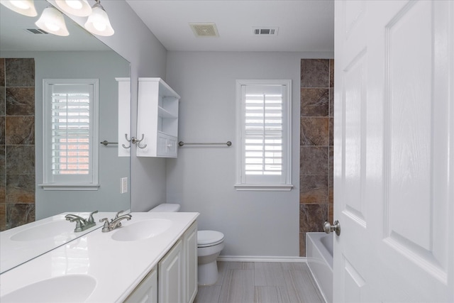 full bathroom with visible vents, toilet, and a sink