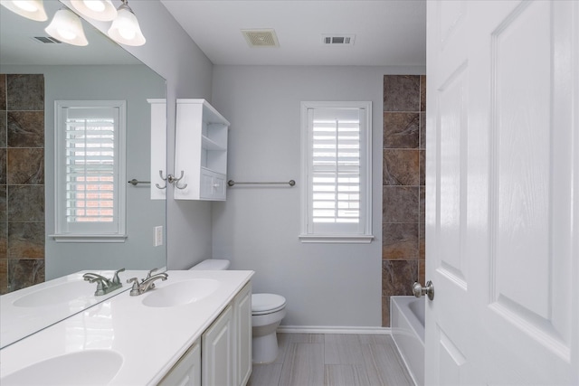 bathroom featuring visible vents, a sink, and toilet