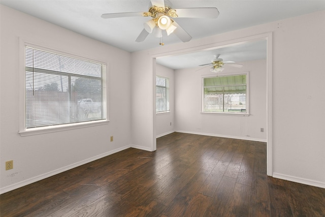 empty room with baseboards and hardwood / wood-style flooring