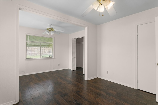 unfurnished bedroom with a closet, dark wood finished floors, a ceiling fan, and baseboards